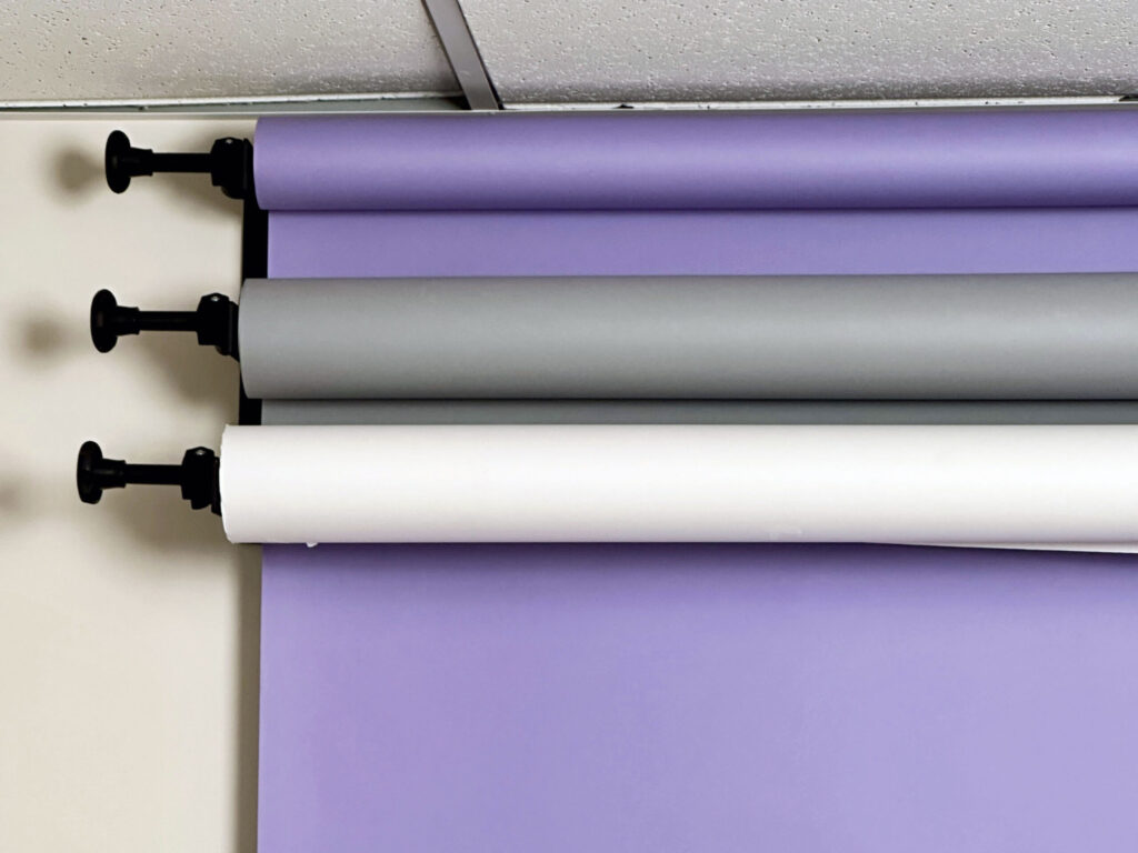 Paper backdrop options (white, grey, light purple)