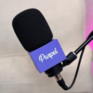 Custom podcast mic flag (mic cube) with Purpel logo on a Shure SM7B microphone